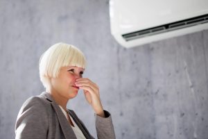 Woman Covering Her Nose From Bad Smell Inside From AC