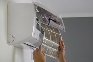 Man holding very dirty air conditioner filter